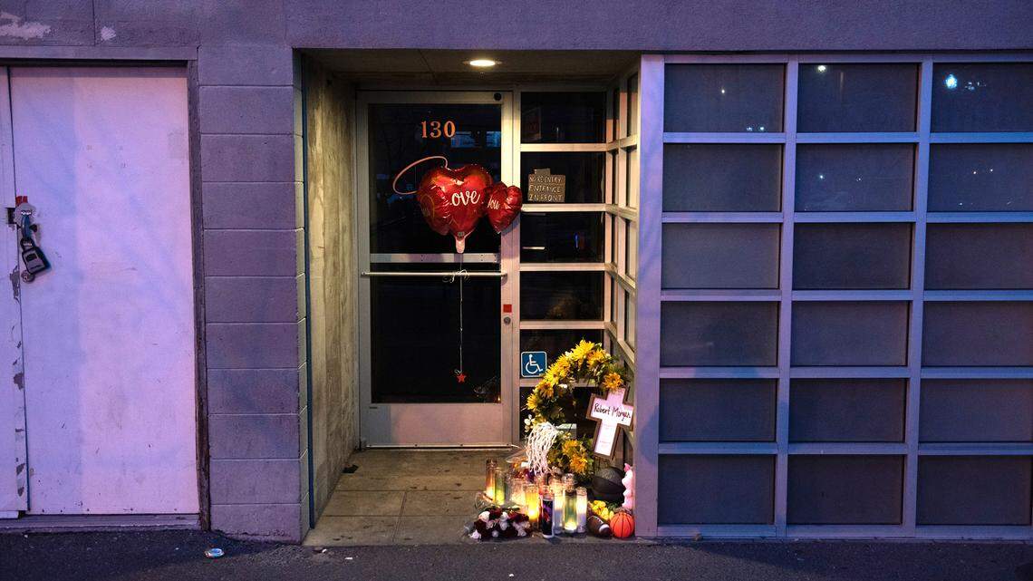 A memorial for security guard Robert Morgan was placed behind the Grand Cru bar in Turlock, Calif., Wednesday, Jan. 18, 2023. Morgan was shot to death outside behind the bar following a confrontation.