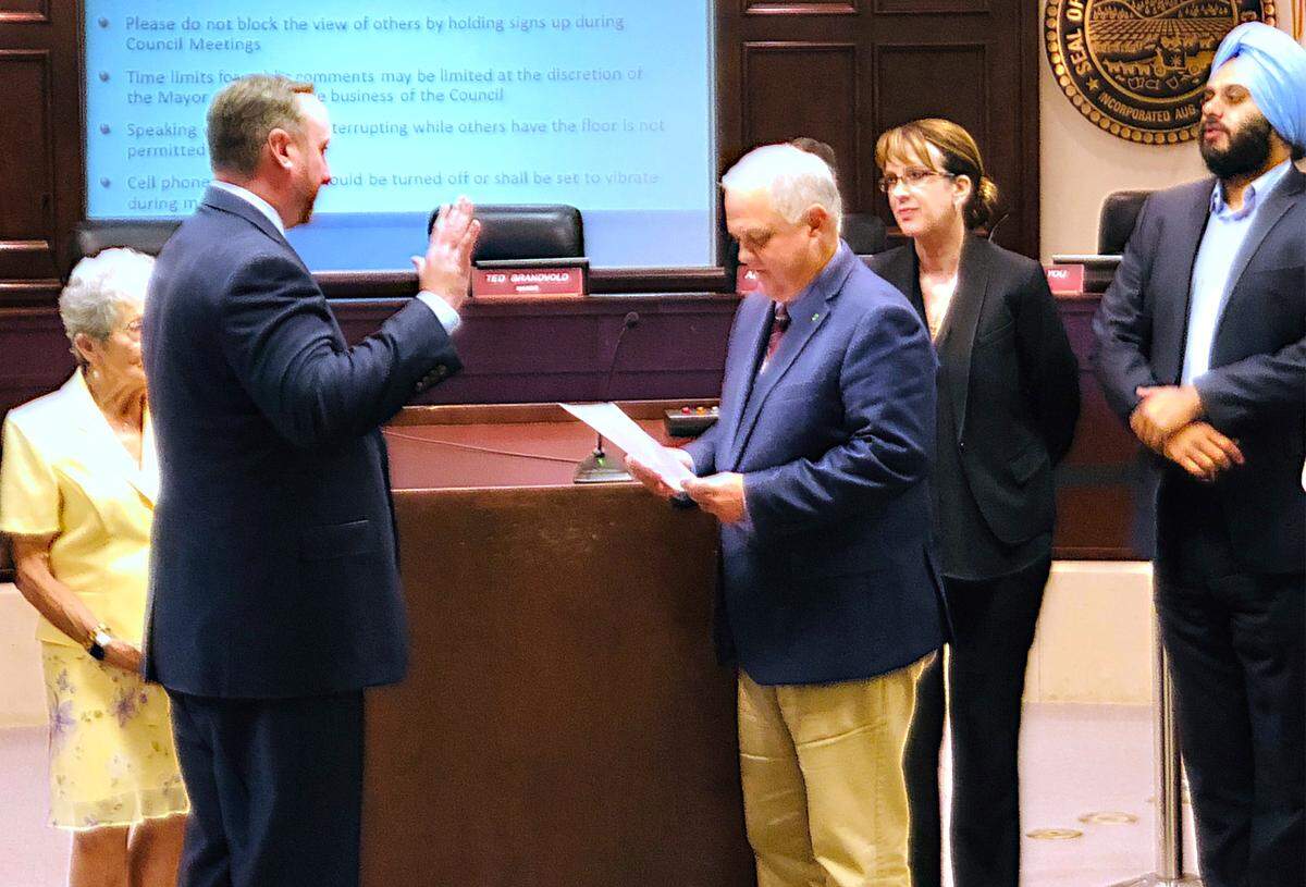 Joe Lopez, left, is sworn in as City Manager by Mayor Ted Brandvold on Tuesday evening, July 10, 2018 in the basement chambers at Tenth Street Place in downtown, Modesto as other council members watch.