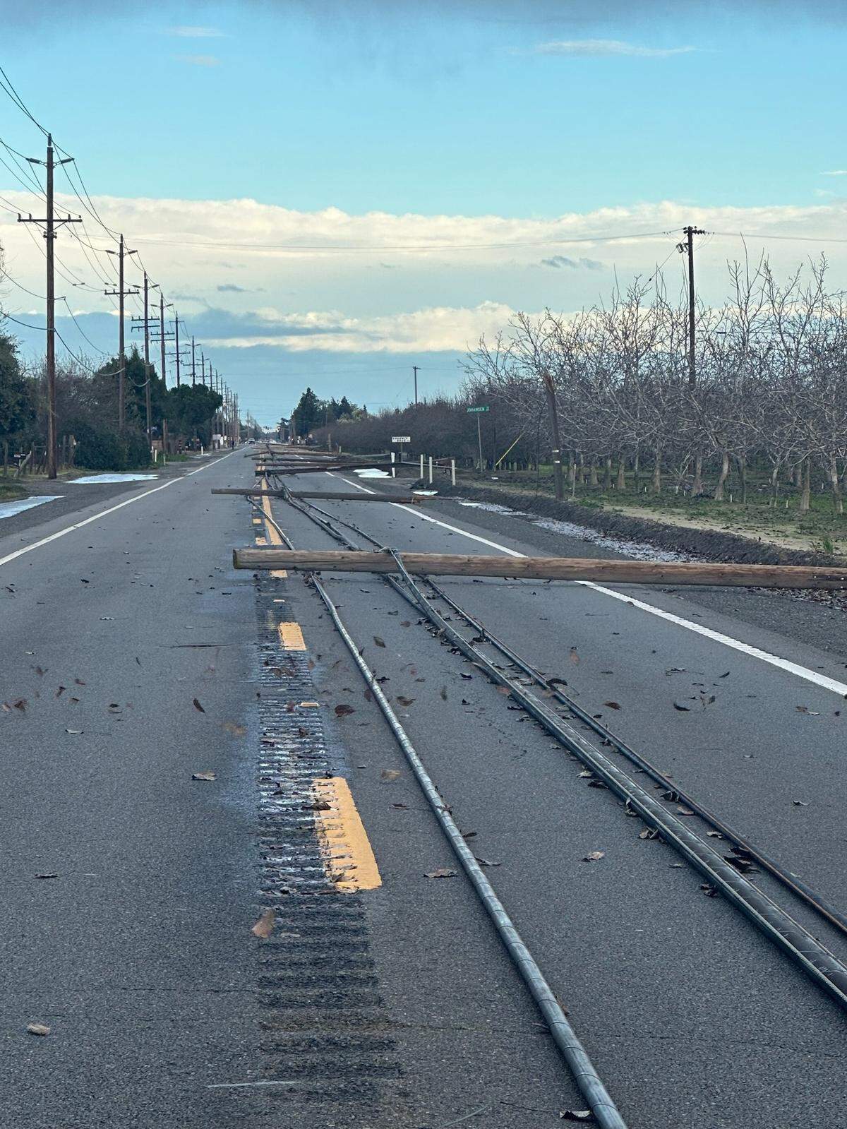 Phone poles and lines lie on Highway 132 east of Empire between Wellsford and Albers/Geer roads on Sunday afternoon, Feb. 4.