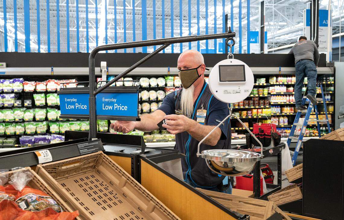 Gary Hodge works in the expanded produce department at the new Walmart Supercenter in Ceres ,Calif., on Wednesday, Nov. 17, 2021.