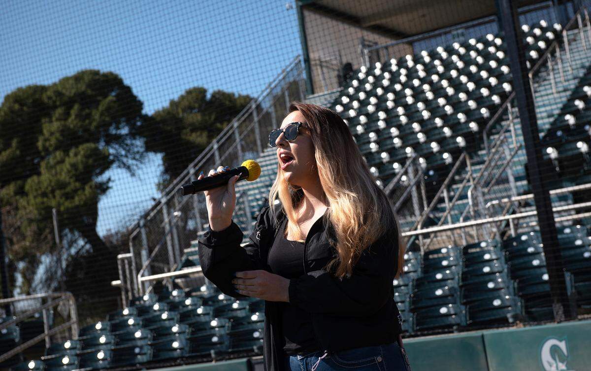 Ariana Flores of Turlock performs the national anthem during a tryout for the chance to sing during a Modesto Nuts game this season. Photographed at John Thurman Field in Modesto, Calif., Thursday, March 16, 2023.