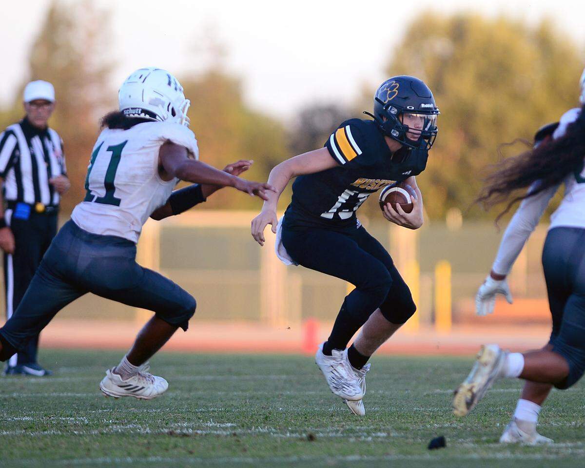 Hughson receiver Bryce McDaniel tries to juke multiple defenders during a game between Hughson High School and Central Valley High School at Hughson High School in Hughson California on August 25, 2023.