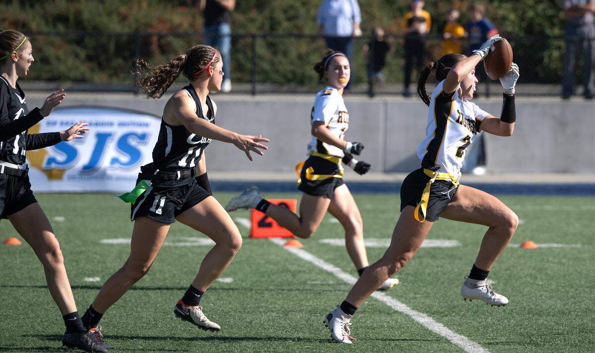 Hughson’s Presley Wells makes a touchdown reception past Colfax defenders during the Sac-Joaquin Section Division 4 championship game at Cosumnes River College in Sacramento, Saturday, Nov. 9, 2024.