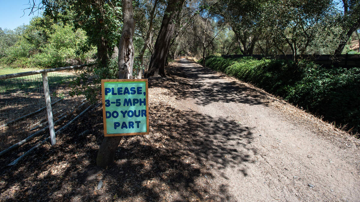 A resident along Old Colony Road near Oakdale put up a sign asking people to limit their speed to 3 to 5 mph if they ride a bike or drive a vehicle on the dirt road.