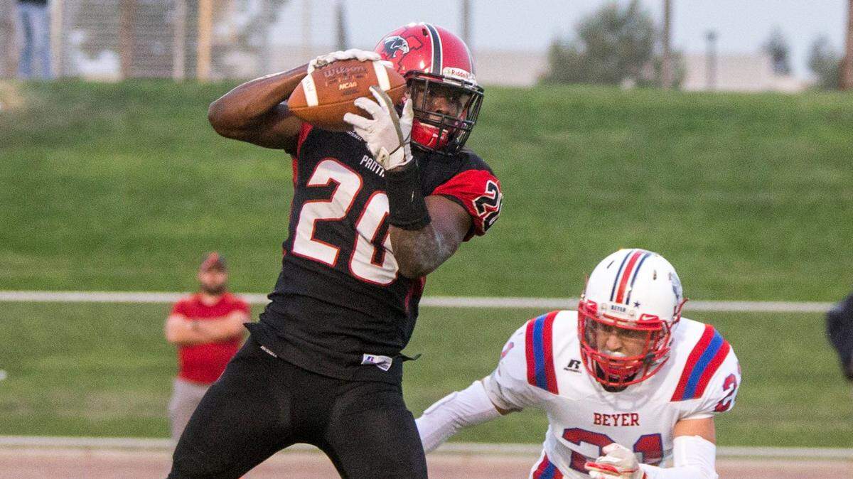  Zaire Eugene, 20, of Modesto High grabs the pass with Ethan Shiffler, 21, closing in. Beyer High took on Modesto High during high school football Friday Aug. 24, 2018
