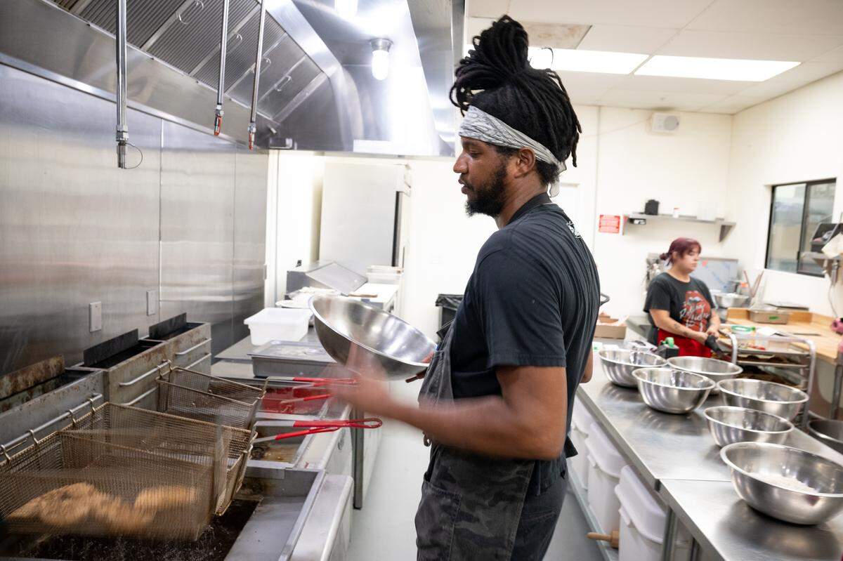 Saucin’ it Up owner Damien Ramsey works in the kitchen in Modesto, Thursday, June 26, 2025.