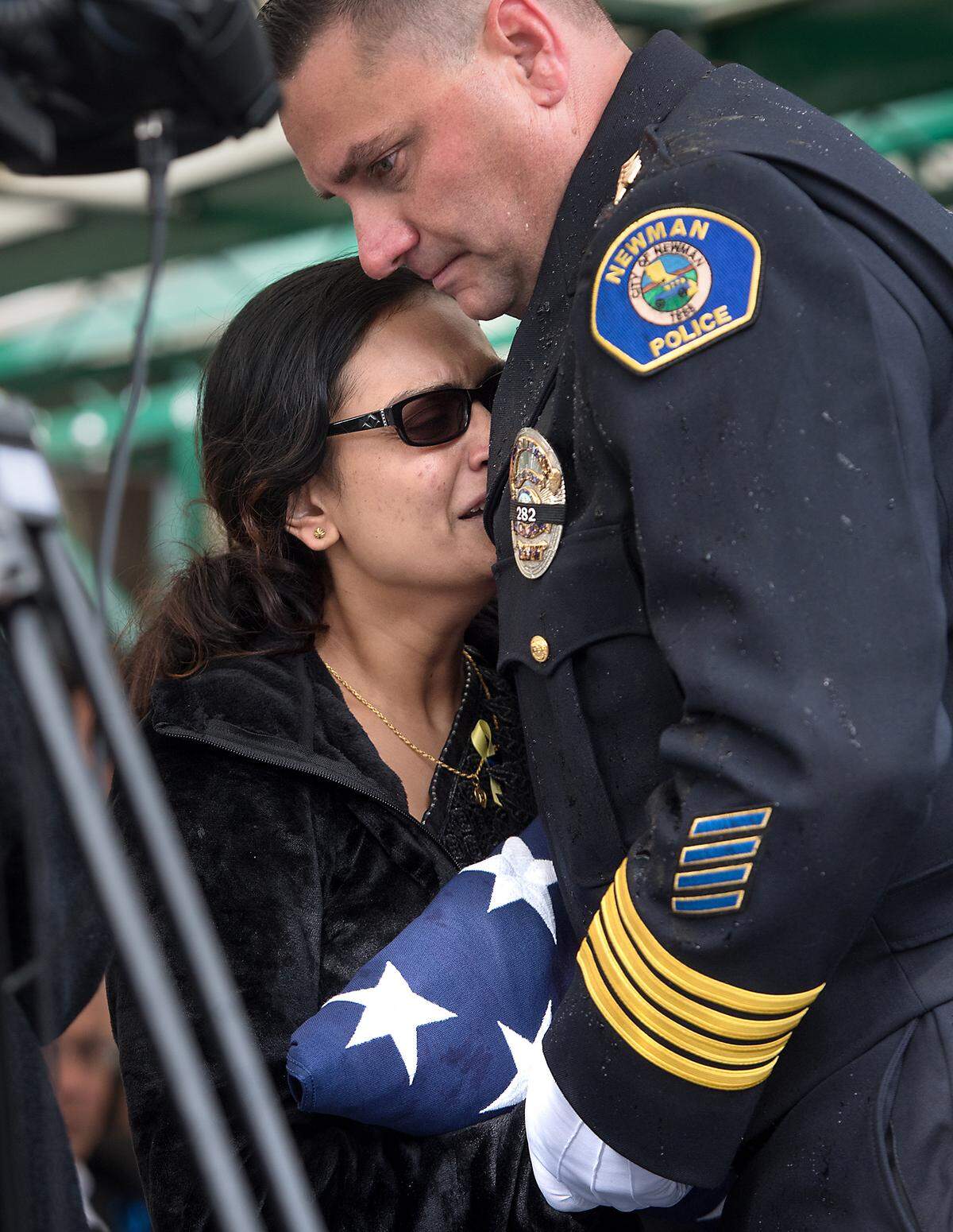 Newman Police Chief Randy Richardson gives widow Anamika Singh the American flag during the funeral for fallen Newman Police Cpl. Ronil Singh at Lakewood Memorial Park in Hughson, Calif., Saturday, Jan. 5, 2019.