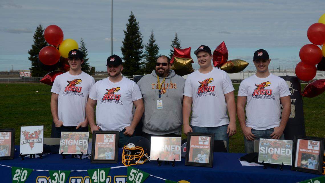 Pictured from left to right: Big Valley Christian seniors Zachary Aloisio and Brandon Carothers, football coach Brian Berkefeld, seniors Spencer Cox and Marcus Lema. The four football players signed with Arizona Christian University on Wednesday, Feb. 2, 2021.