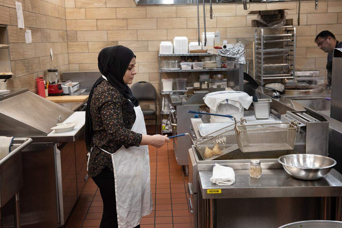 Cook Shayma Mirzada works on the vegetarian side of the kitchen at Tandoori Flame restaurant in Patterson, Calif., on Friday, April 22, 2022.