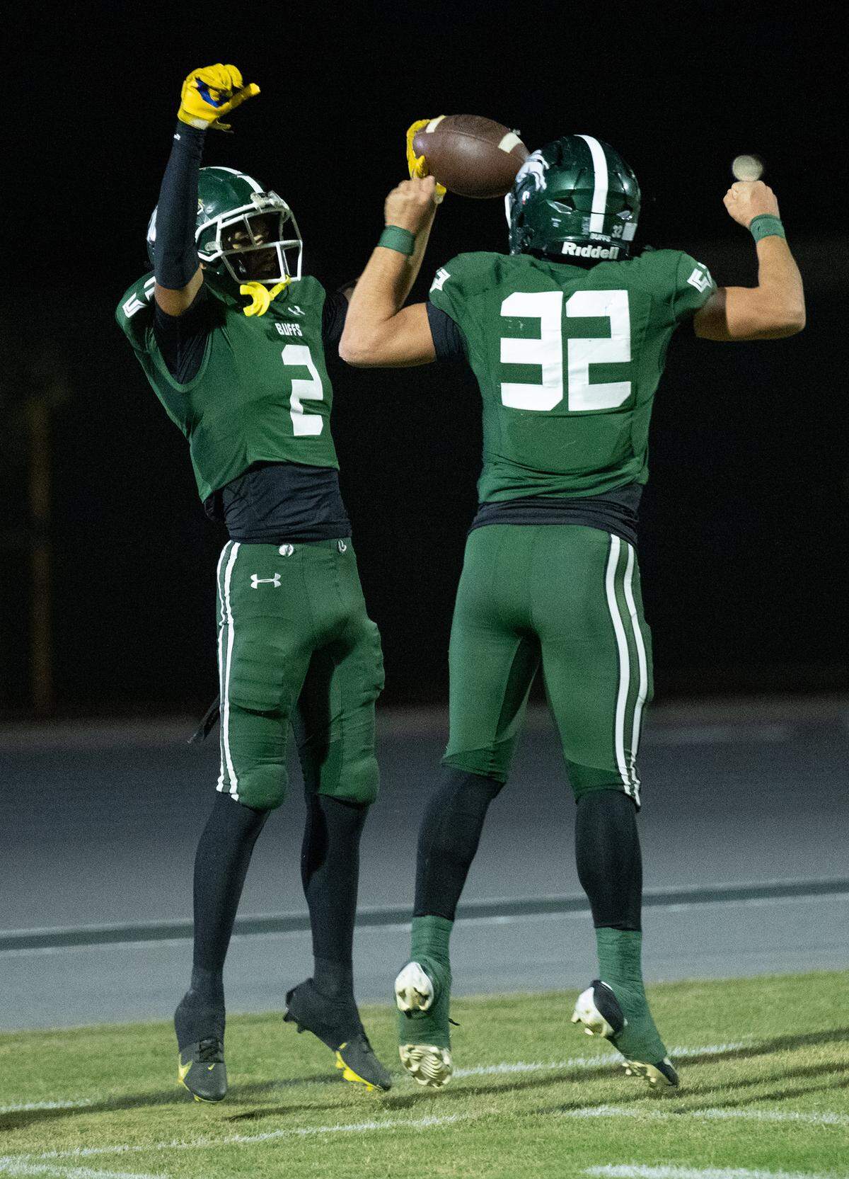 Manteca’s Quinn Martinez (2) and Nikko Juarez celebrate a touchdown during the Valley Oak League game with Oakdale at Manteca High School in Manteca, Friday, Nov. 1, 2024.