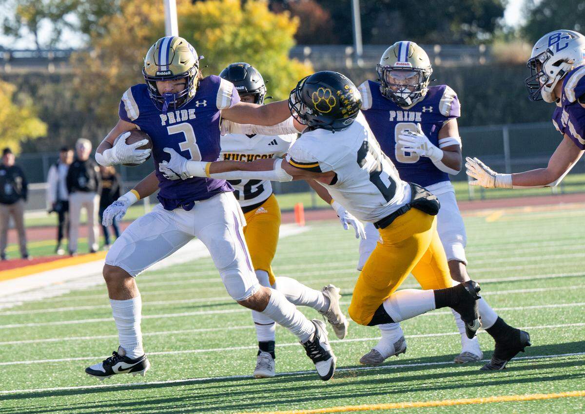 Bradshaw Christian’s Brandon Burden fights off Hughson’s David Delgado on a run during the Sac-Joaquin Section Division VI championship game at Sacramento City College in Sacramento, Calif., Saturday, Nov. 25, 2023.
