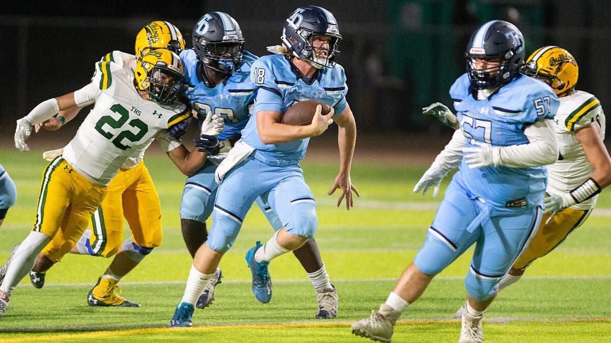 Downey quarterback Conner Stoddard scrambles for a short gain during the nonleague game with Tracy at Downey High School in Modesto, Calif., on Friday, September 16, 2022.