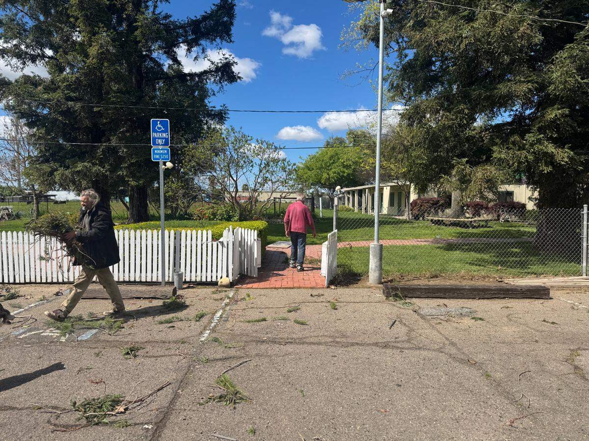 Volunteers for the Unitarian Universalist Fellowship of Stanislaus County clean up limbs and other debris scattered around the church after a tornado touched down on Tuesday, April 1 in Modesto.