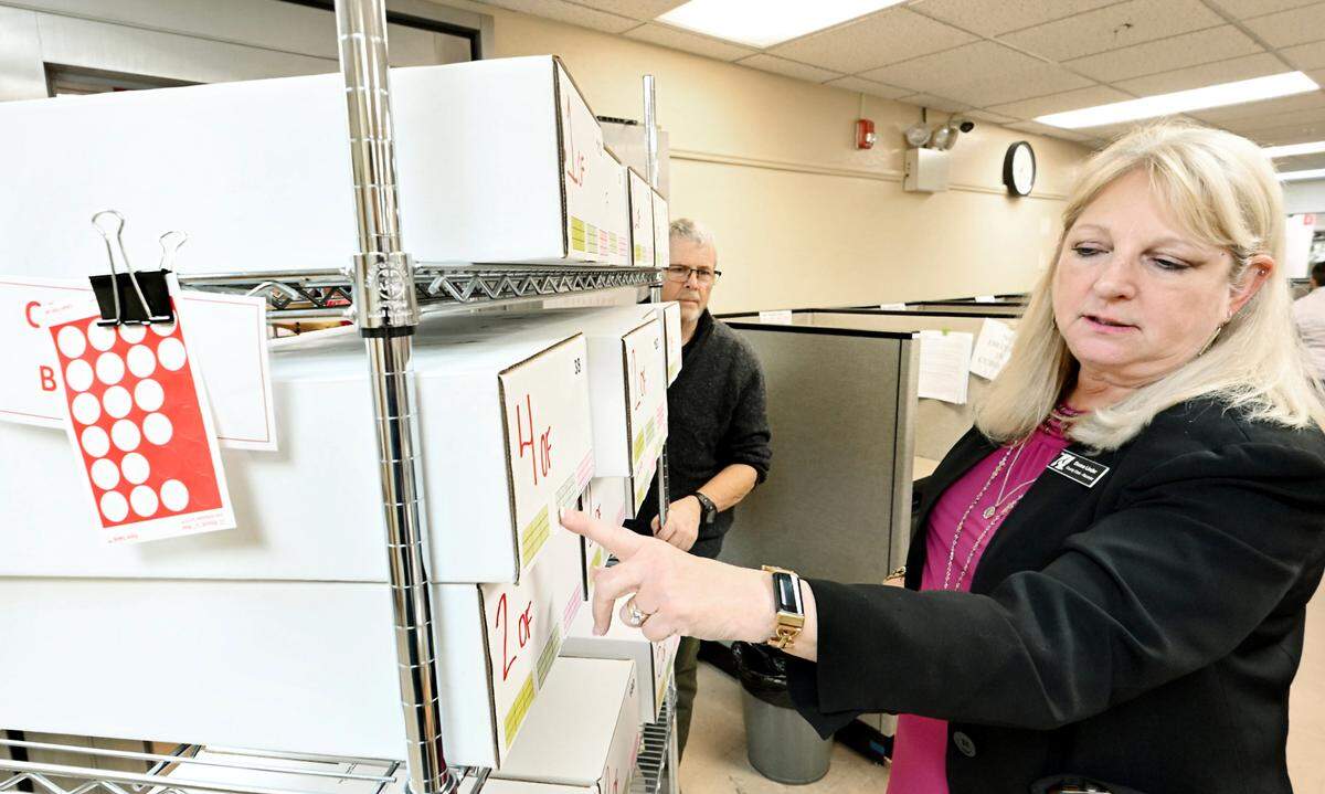 County Clerk-Recorder Donna Linder points to sealed boxes of counted ballots at the Stanislaus County Registrar of Voters Office in Modesto, Wednesday, Oct. 23, 2024.
