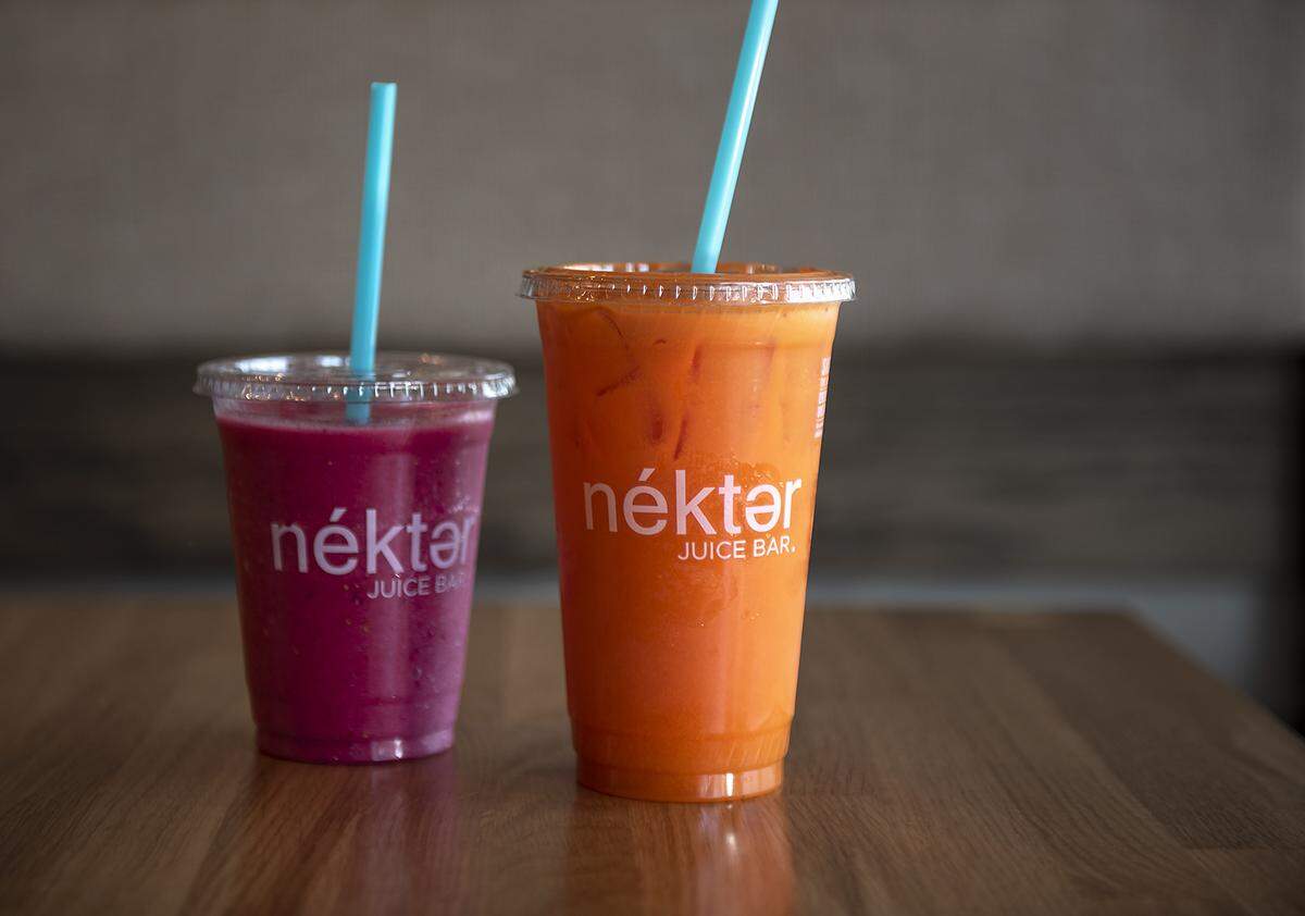 Pink Flamingo smoothie (dragon fruit, strawberry, pineapple, agave nectar, and coconut water), left, and The Buzz pressed juice (carrot, orange, lemon and ginger) at Nekter Juice Bar in Modesto, Calif., Friday, July 26, 2019.