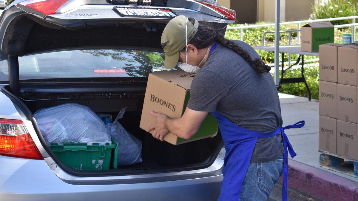 Students pick up food boxes from the Pirates Pantry Relief Project at the Modesto Junior College East Campus on Thursday, April 23, 2020.
