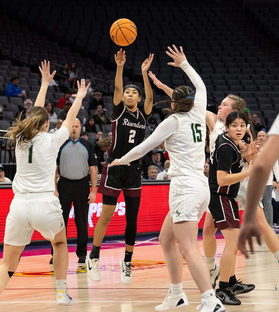 Riverbank’s Taylor Macias launches a three-point attempt under pressure from a trio of Liberty Ranch defenders during the Sac-Joaquin Section D-4 championship game at the Golden 1 Center in Sacramento, Thursday, February, 27, 2025.