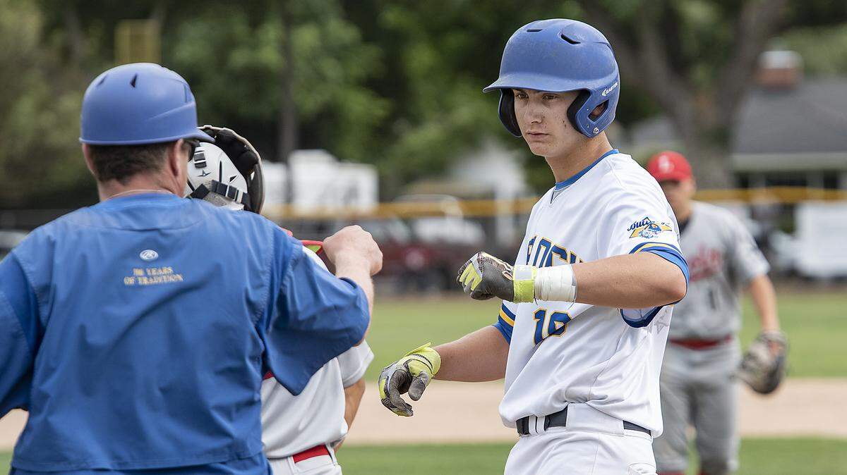 Turlock’s Tyler Soderstrom fists bumps with his coach during the Sac-Joaquin Section baseball playoff game with Lincoln at Turlock High School in Turlock, Calif., Tuesday, May 14, 2019.