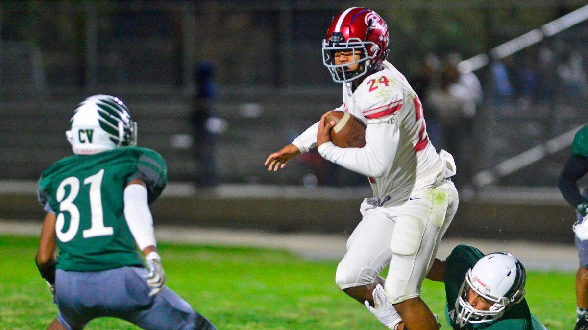 Patterson running back Lolo Mataele (24) eyes a defender after breaking a tackle during a game between Patterson High School and Central Valley High School at Ceres High School in Ceres California on October 8, 2021.