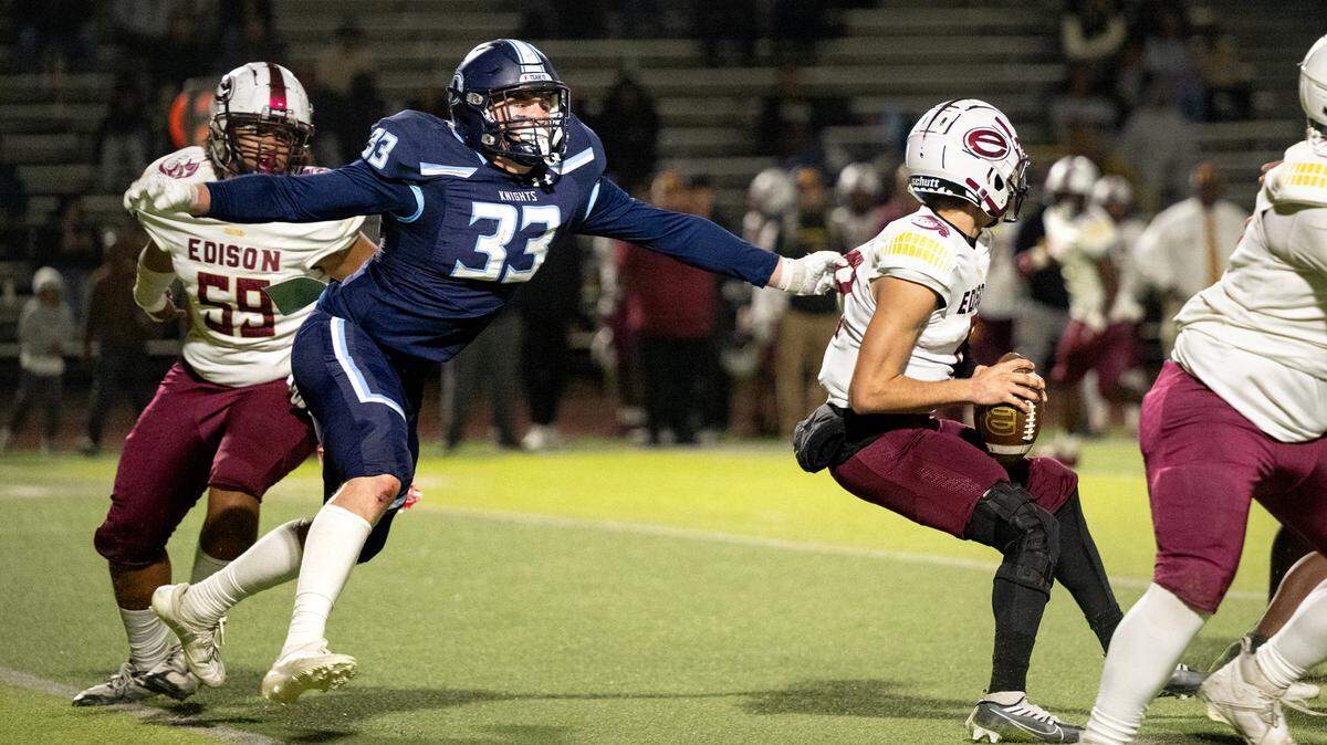 Downey’s Noah Sacuskie tracks Edison quarterback Devin Rasmussen during the Sac-Joaquin Section D1 playoff game with Edison at Downey High School in Modesto on Friday, Nov. 8, 2024.