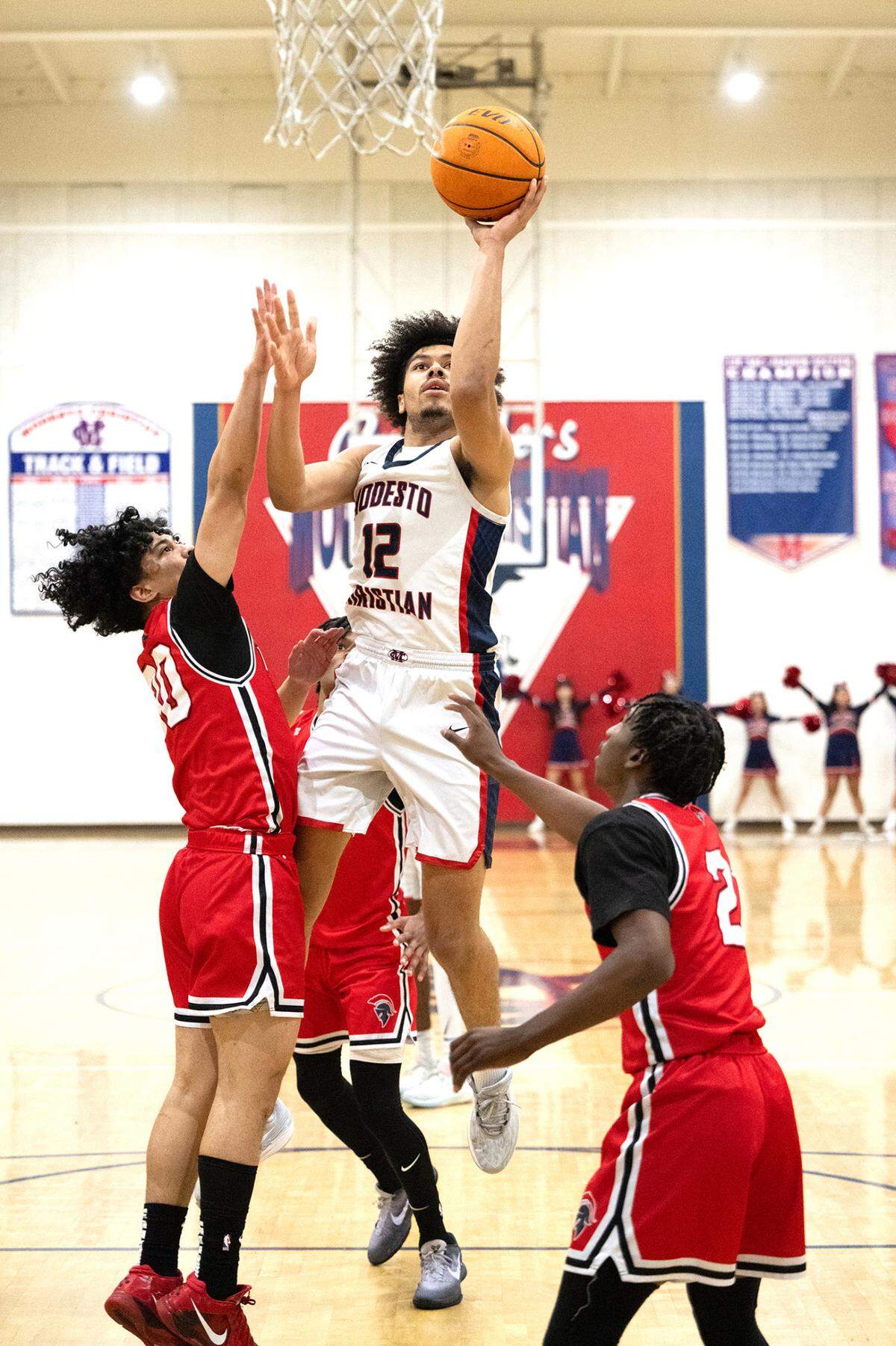 Modesto Christian’s Marcus Washington scores over Lincoln defenders during the Tri-City Athletic League game at Modesto Christian High School in Salida, Calif., Friday, Jan. 12, 2024.