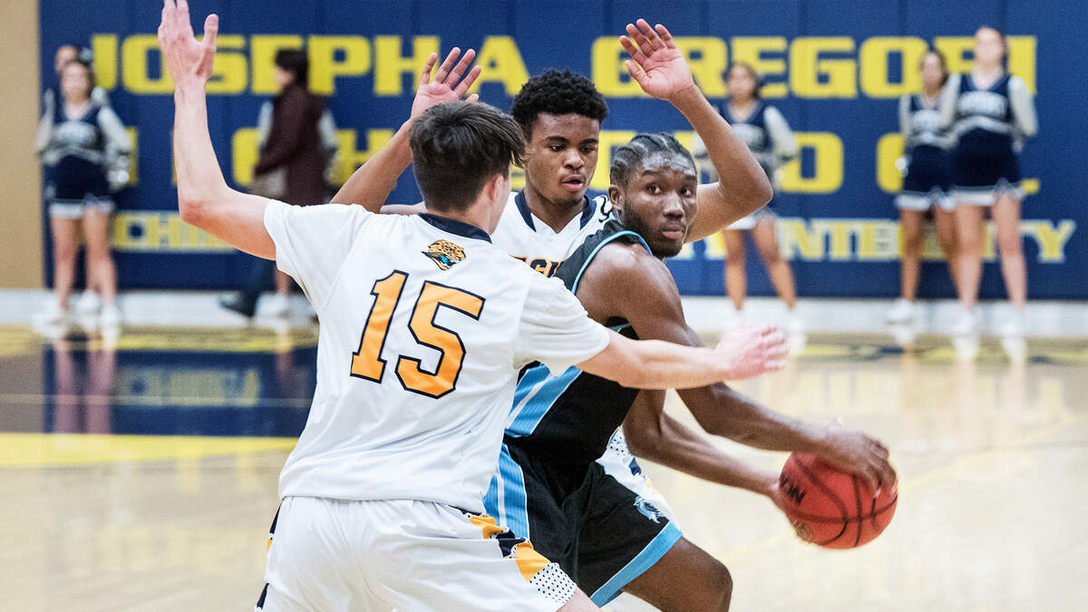 Downey’s Lawrence Harris looks to pass as Gregori’s Kyle Monk (15) and Jamin Crenshaw defend during the Central California Athletic League game at Gregori High School in Salida, Calif., Friday, Feb. 1, 2019.
