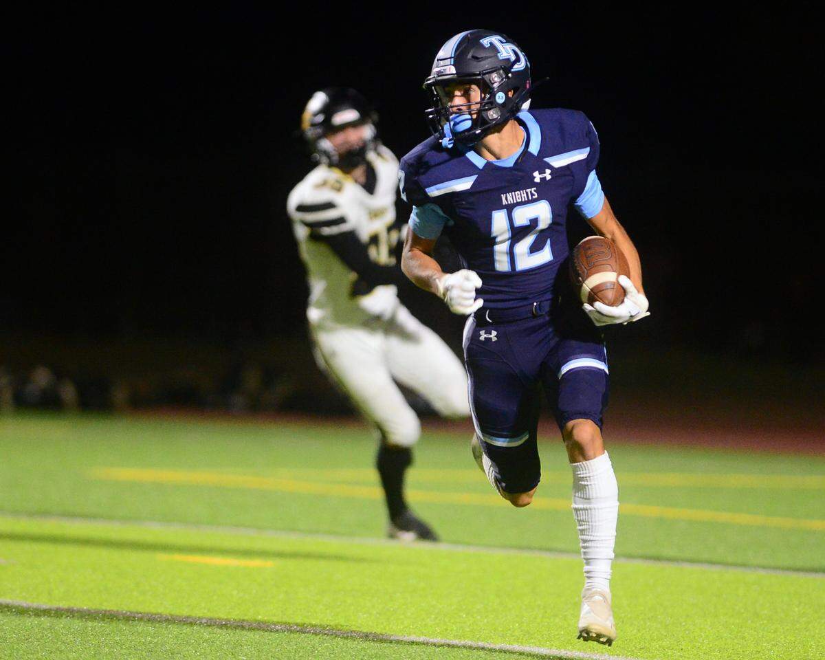 Downey receiver Gabe Hernandez sprints upfield on a sweep during a game between Downey High School and Enochs High School at Downey High School in Modesto CA on October 13, 2022.