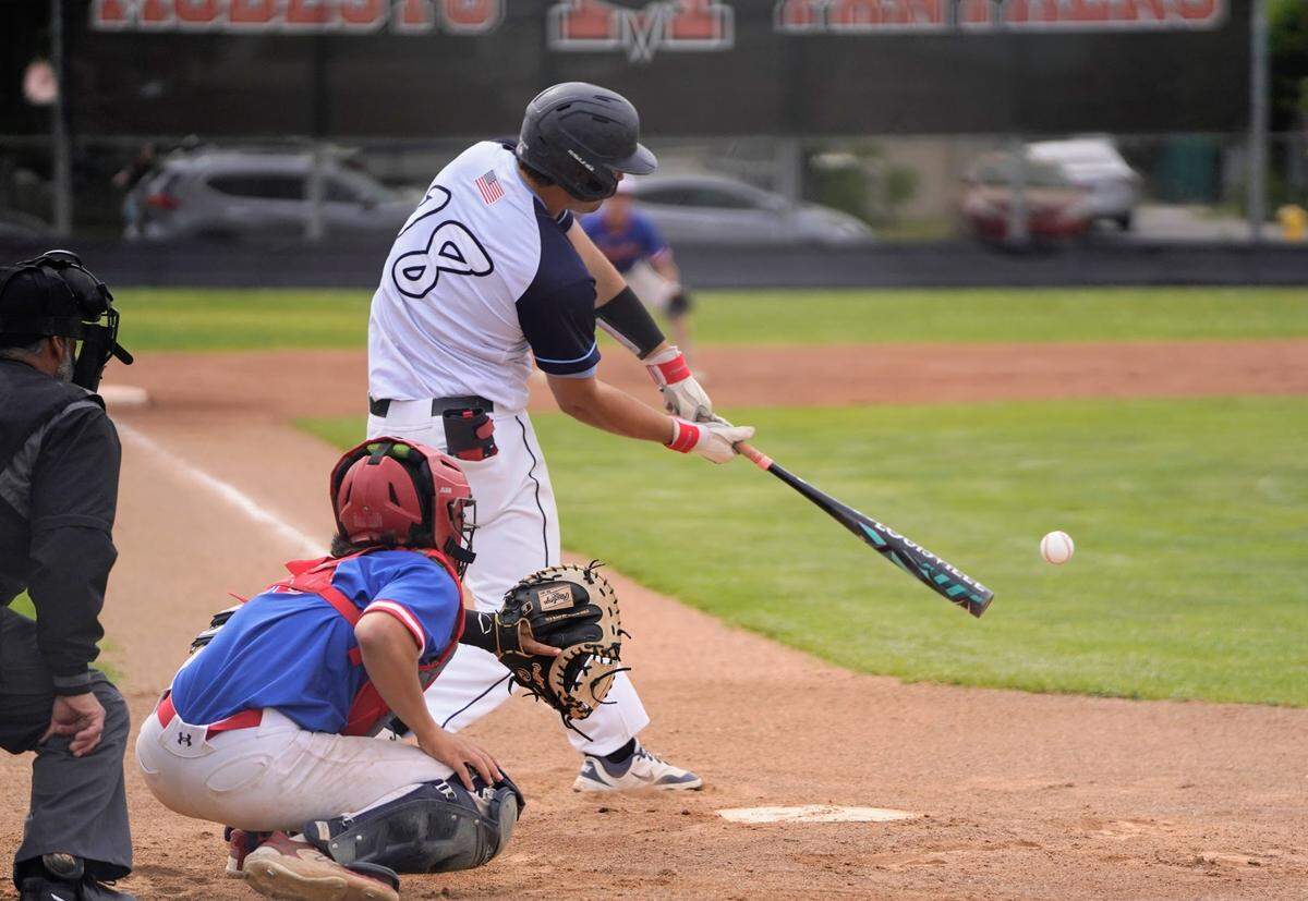 Downey’s Ryne Moore makes contact with a pitch during the championship game of the Windemuth Tournament against Beyer at Modesto High School on Thursday, April 24, 2025.