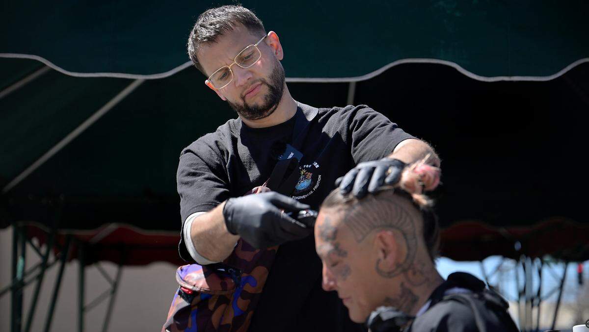Paul Samsin, aka Sammy, cuts the hair of Luckie Luchianna in Modesto, Tuesday, April 8, 2025.