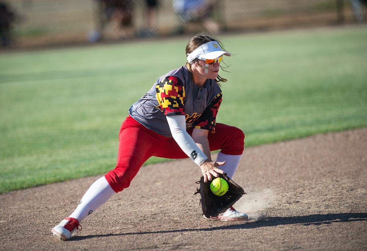 Oakdale shortstop Amanda Bricker gathers a hard hit grounder during the CIF Sac-Joaquin Section Softball semifinal playoff game with Central Catholic at Central Catholic High School in Modesto Calif., on Tuesday, May 24, 2022.