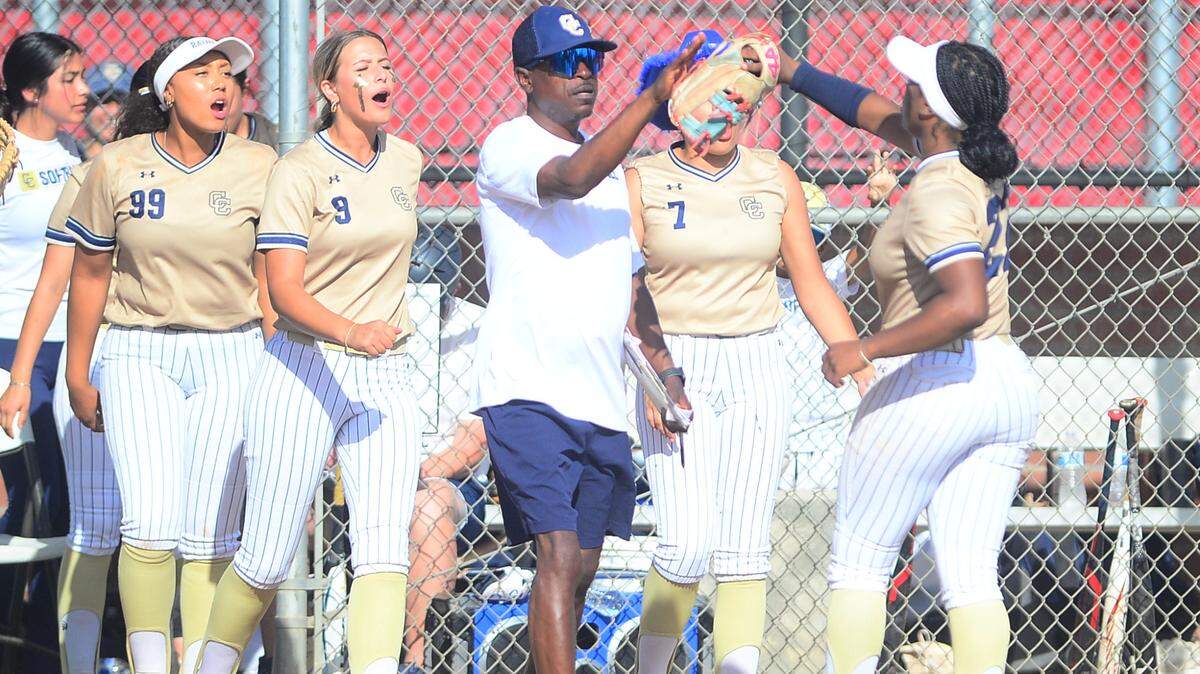 Central Catholic head coach Sam Nichols (center) celebrates with his players after they turned a double play during a game between Oakdale and Central Catholic at Oakdale High School in Oakdale, Calif. on April 17, 2024. Central Catholic won 6-2.