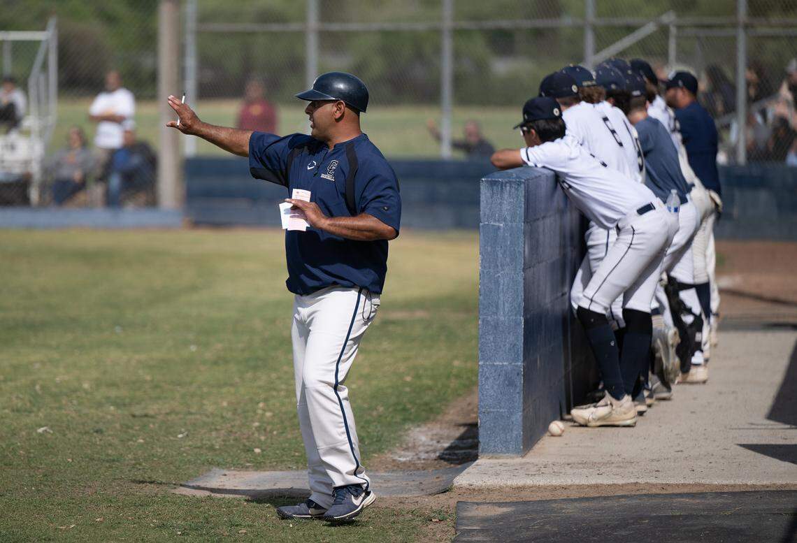 Central Catholic head coach Danny Ayala sets up the defense at the start the first round playoff game with Los Banos at Central Catholic High School in Modesto, Calif., Tuesday, May 9, 2023.