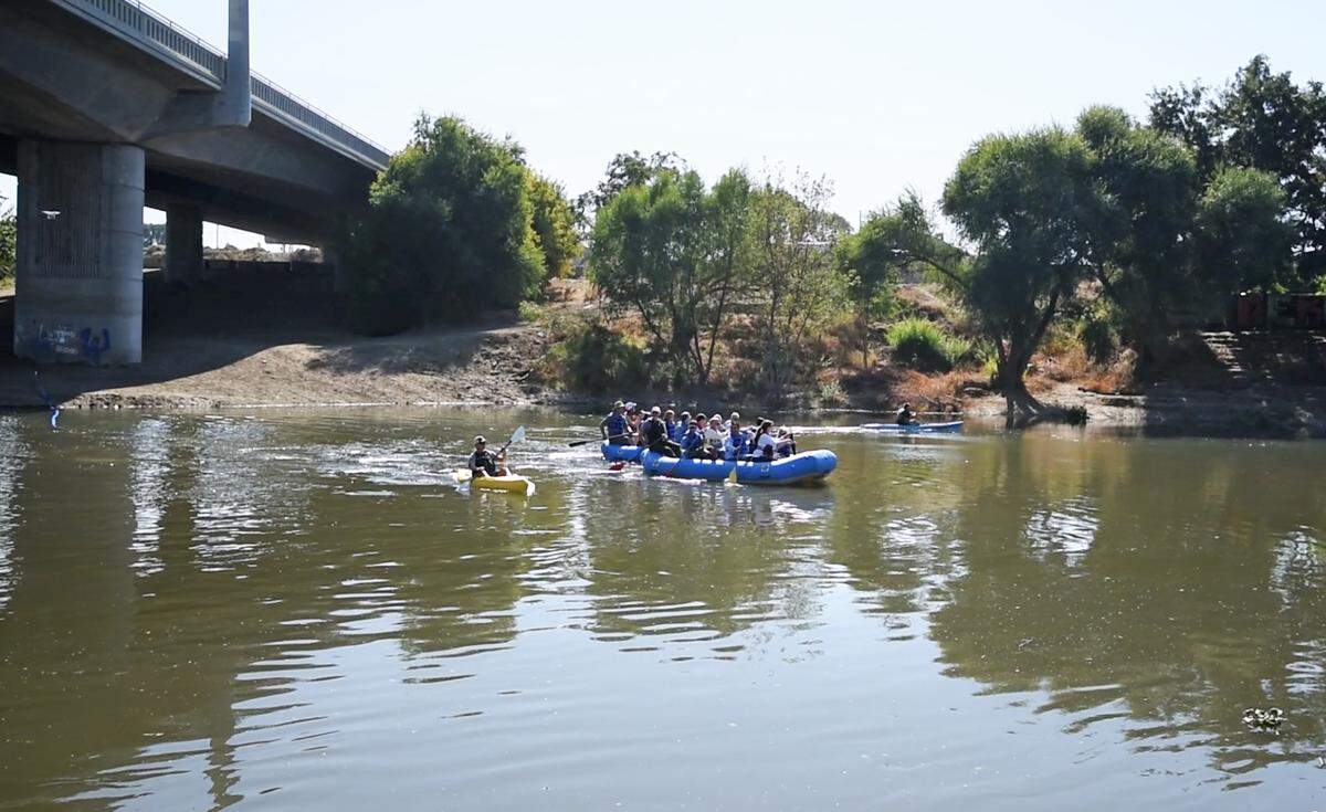 Community leaders float down the Tuolumne River to celebrate the removal of the Dennett Dam near the 9th Street Bridge in Modesto, Ca., on Thursday, Oct. 18, 2018.