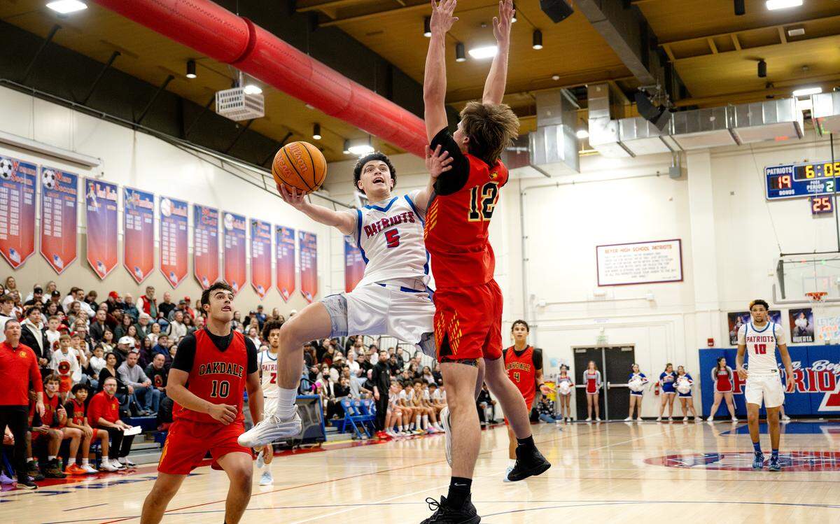 Beyer’s James McGee drives to the hoop defended by Oakdale’s Niki Jones during the Sac-Joaquin Section D-III playoff game with Oakdale at Beyer High School in Modesto on Wednesday, Feb. 18, 2026.