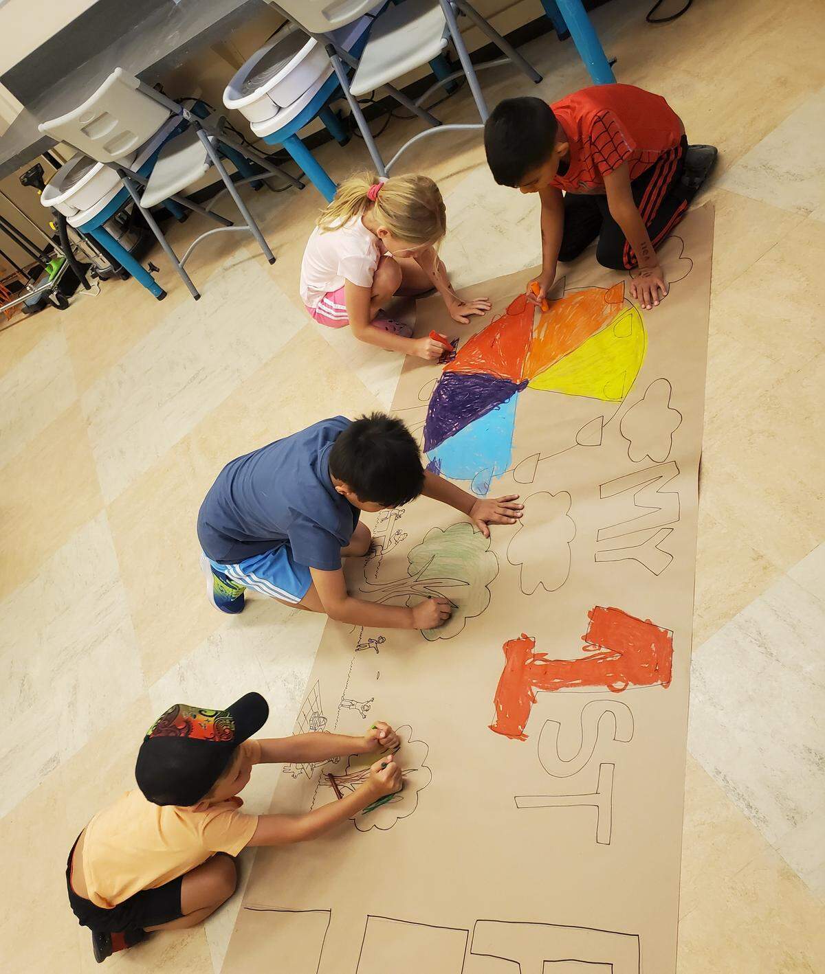 Youths busily creating during a Carnegie Arts Center 2025 summer art camp.
