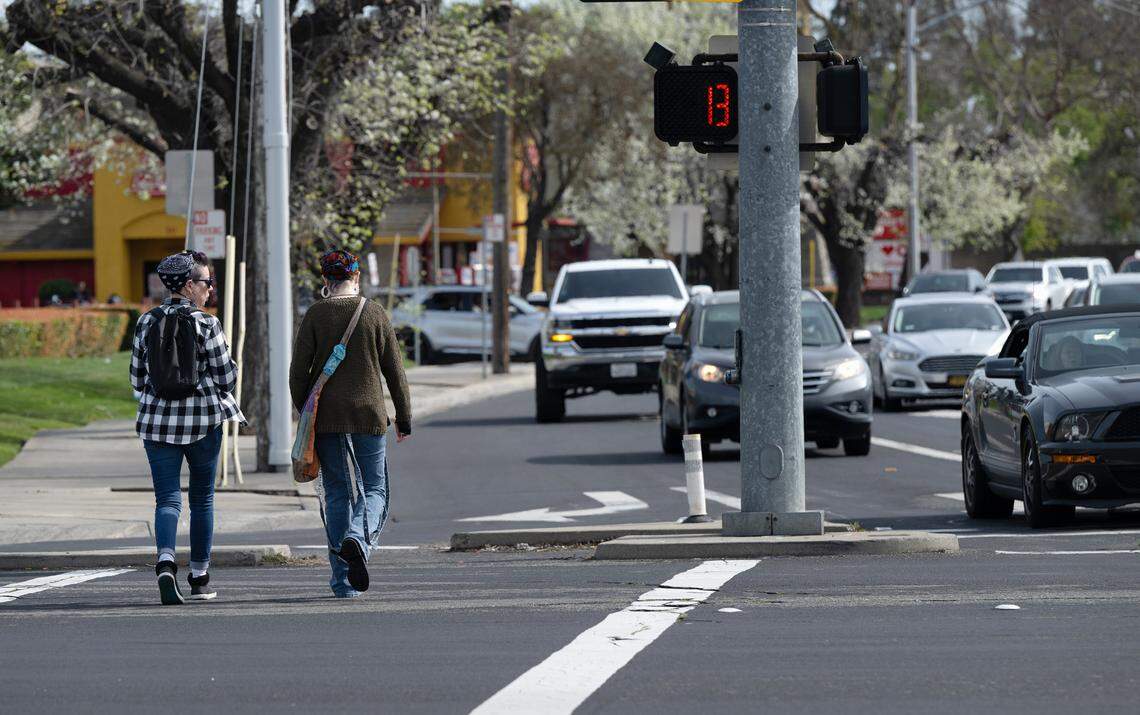 Pedestrians cross Standiford Avenue in Modesto, Calif., Saturday, March 9, 2024.