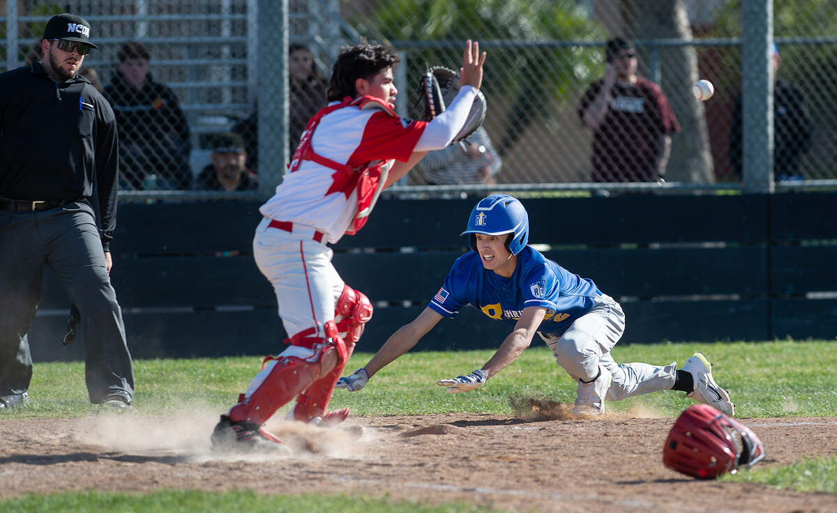Ripon Christian’s Luke Crivello beats the throw to Modesto catcher Ricky Hernandez in the championship game of the Windemuth Tournament at Modesto High School in Modesto, Calif., Thursday, April 13, 2023.