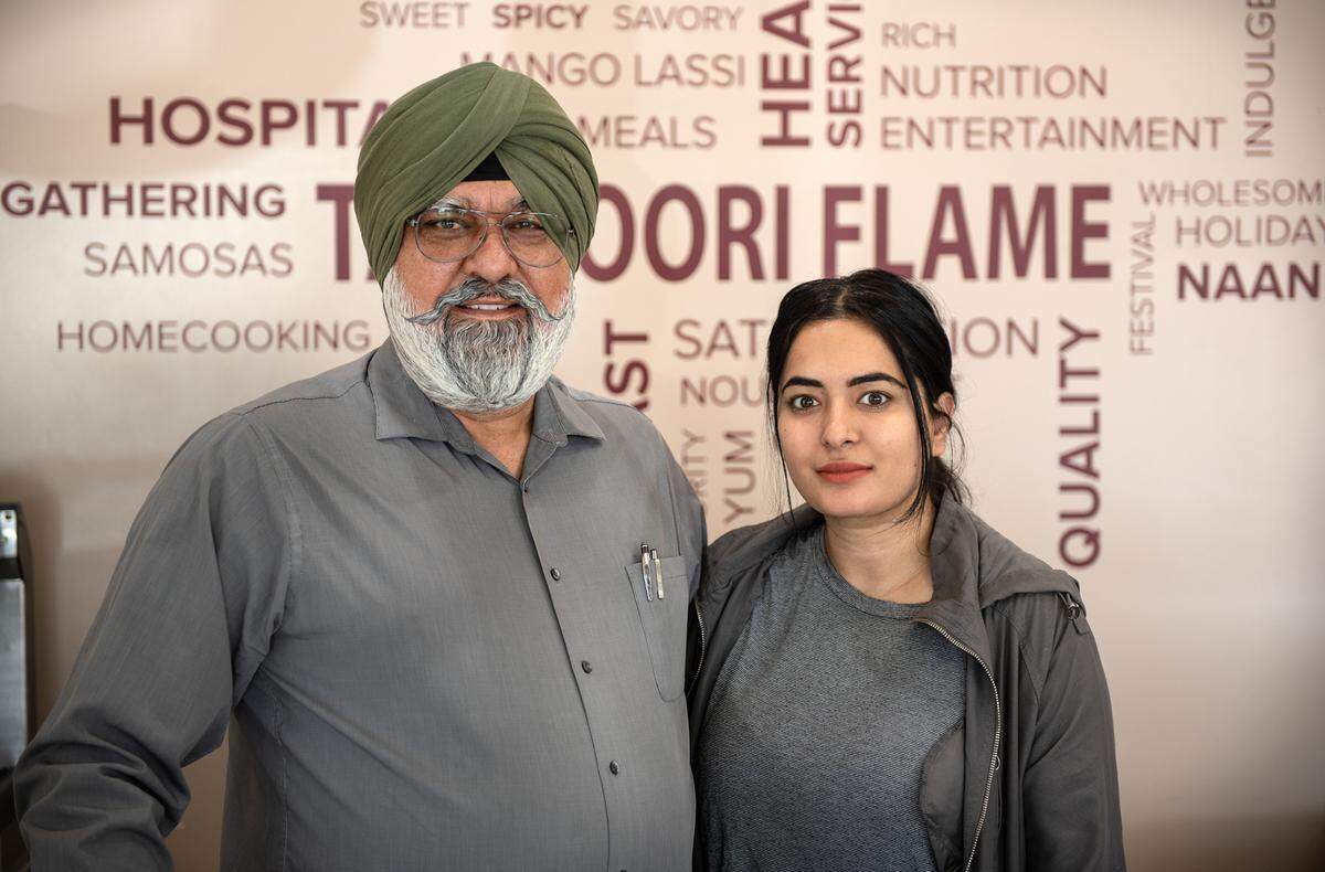 Father and daughter owners Amarjit and Simran Dhanju at Tandoori Flame restaurant in Patterson, Calif., on Friday, April 22, 2022.