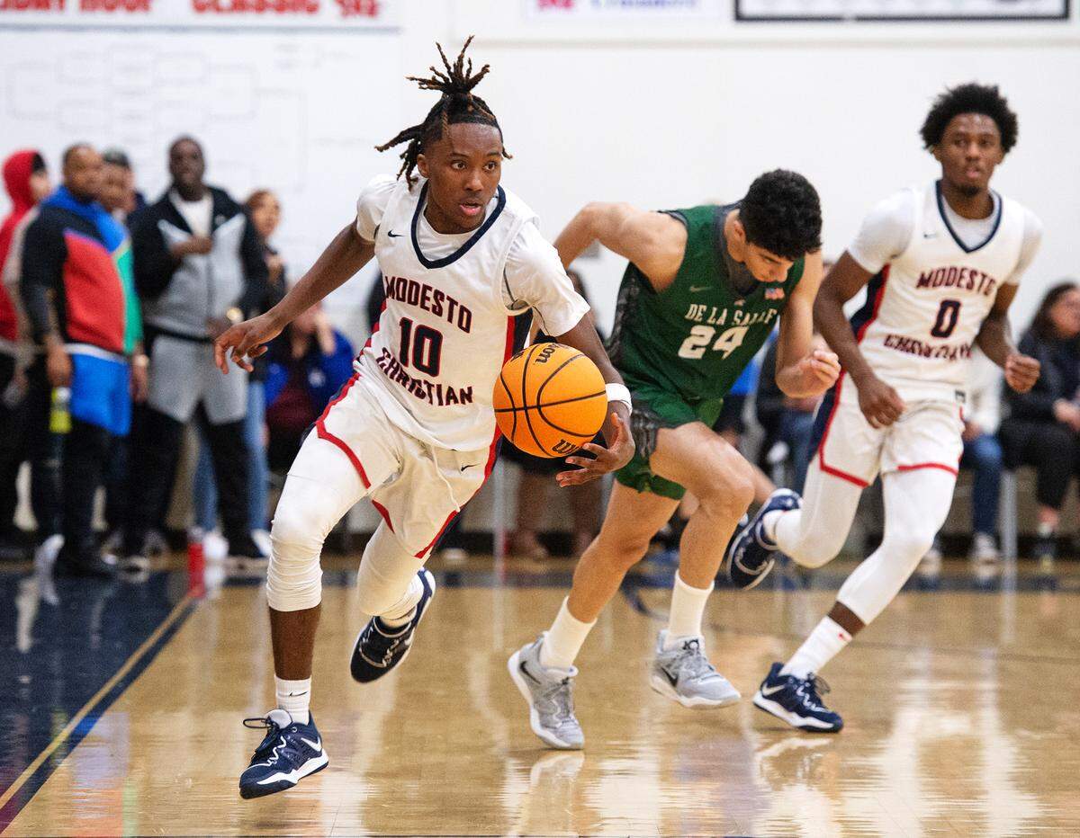 Modesto Christian’s BJ Davis recovers a loose ball during the NorCal Open Division semifinal playoff game with De La Salle in Salida, Calif., Saturday, March 4, 2023.