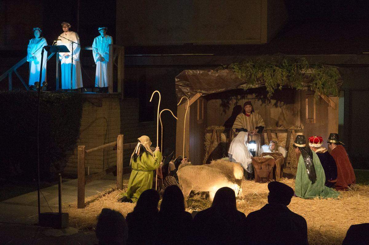 People sit and watch a live nativity reenactment of a the biblical Christmas story that was put on by Modesto Free Methodist Church of Modesto on Rose Avenue Friday Dec. 14, 2018 evening.