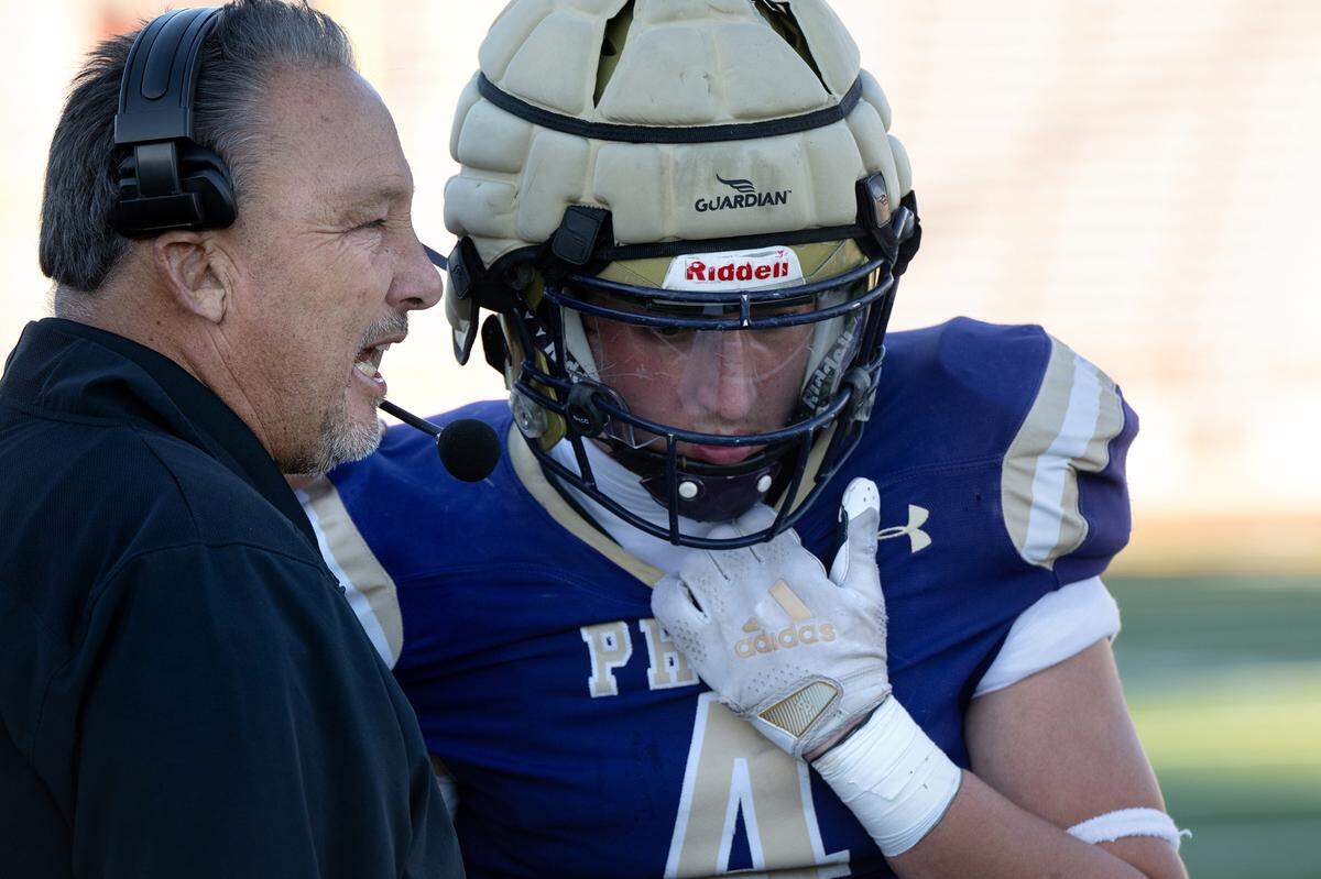 Bradshaw Christian coach Drew Rickert talks with Brandon Burden during the Sac-Joaquin Section Division VI championship game with Hughson at Sacramento City College in Sacramento, Calif., Saturday, Nov. 25, 2023.