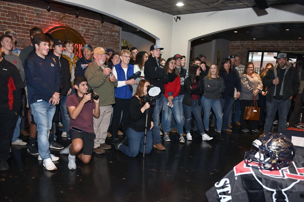 Friends and family are present as Turlock high school senior Garret Fountain signs his letter of intent with San Diego State University on Friday December 21, 2018 at Red Brick Bar & Grill in Turlock, Calif.