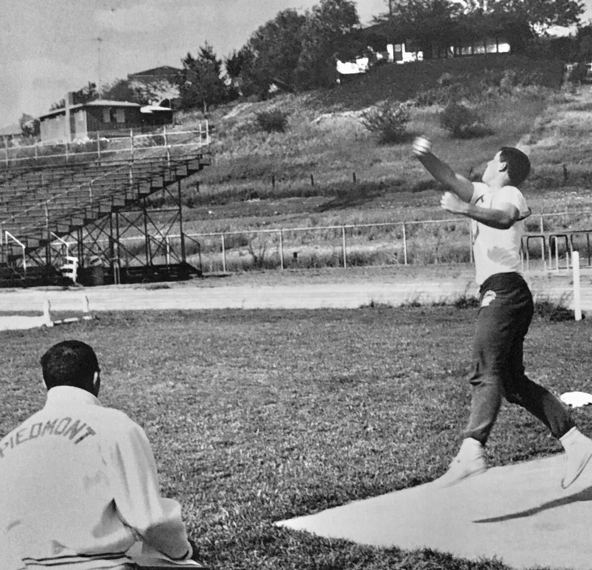 Jack Albiani coaches discus thrower Jim Peters at Piedmont High in the mid-1960s.
