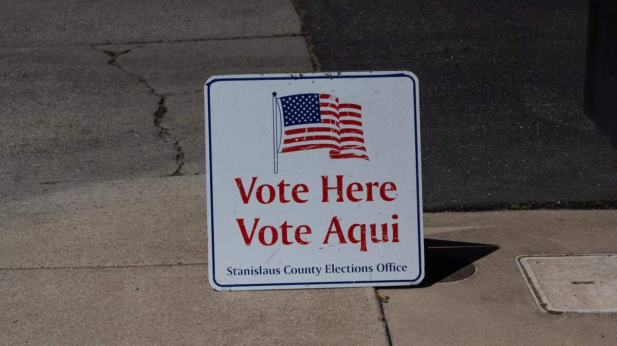 Election sign outside a California polling place; election officials say turning in ballots early can help speed up processing.