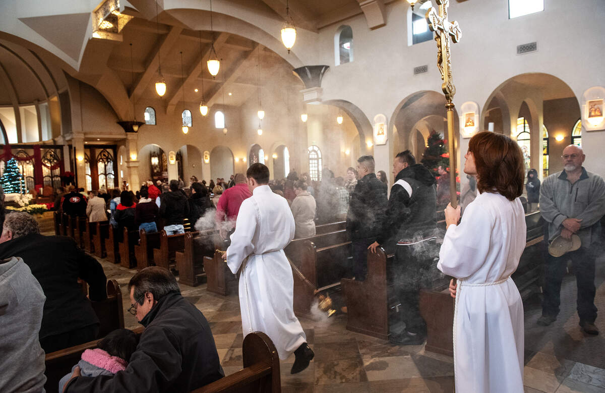 Altar boys carry incense into the nave to start the Christmas Mass at St. Stanislaus Catholic Church on Maze Boulevard in Modesto, Calif., Sunday, Dec. 25, 2022.