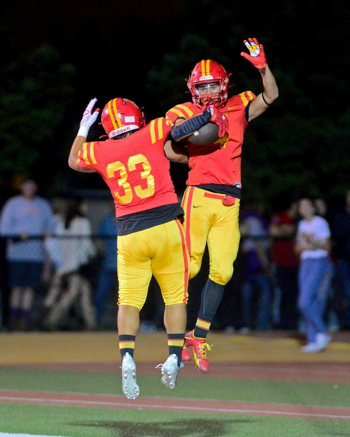 Oakdale receiver Joseph Delte (4) celebrates with teammate Angel DeAnda (33) after scoring a touchdown during a game between Oakdale and Escalon at Oakdale High School in Oakdale, California, on September 15, 2023.