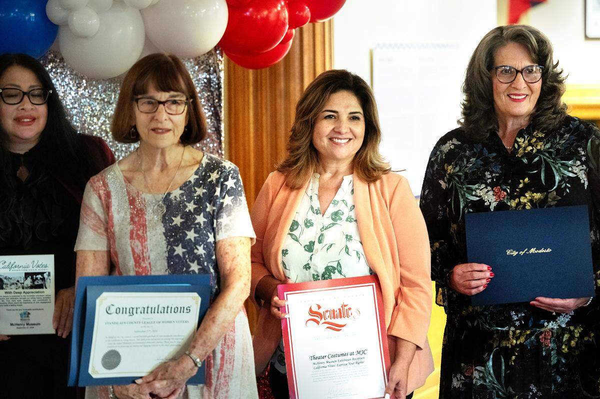 From the right, Modesto mayor Sue Zwahlen, State Sen. Marie Alvarado-Gil, Marsha Waggoner, president of the Stanislaus League of Women Voters and city clerk Diane Nayares-Perez‘ pose for pictures during the opening of the California Votes: Exercise Your Right!’ exhibit at the McHenry Museum in Modesto, Calif., Friday, Sept. 27, 2024.