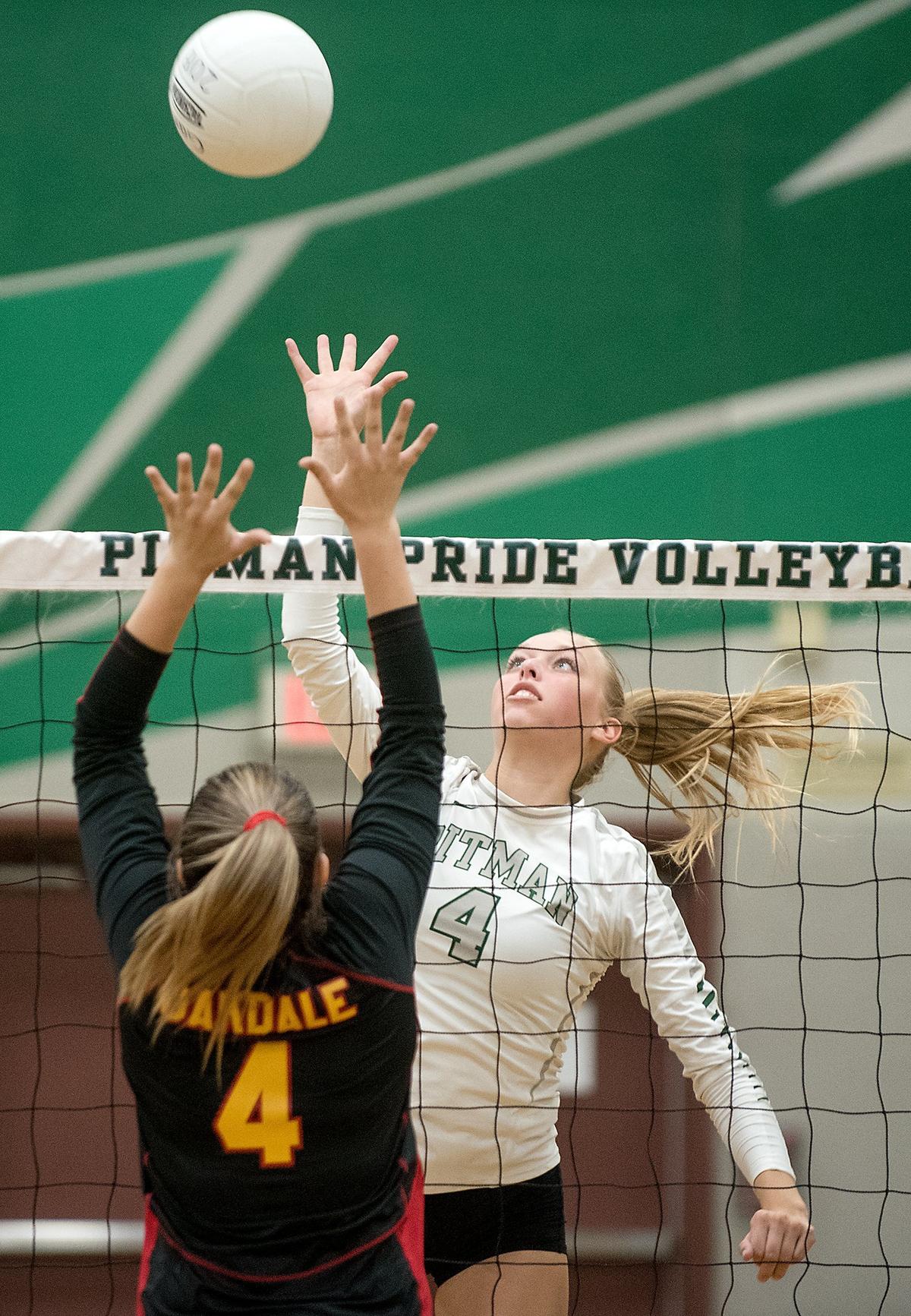 Pitman’s Avery Carlson (4) floats the ball over Oakdale’s Alyssa Cogburn (5) during Thursday’s match at Pitman High School n Turlock, Calif., August 30, 2018.