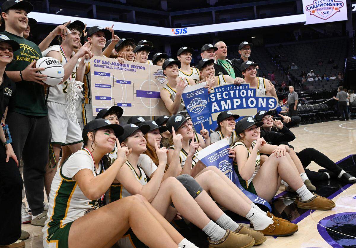 Placer High’s boys and girls basketball teams pose together after sweeping the CIF Sac-Joaquin Division III championships at Golden 1 Center on Saturday.