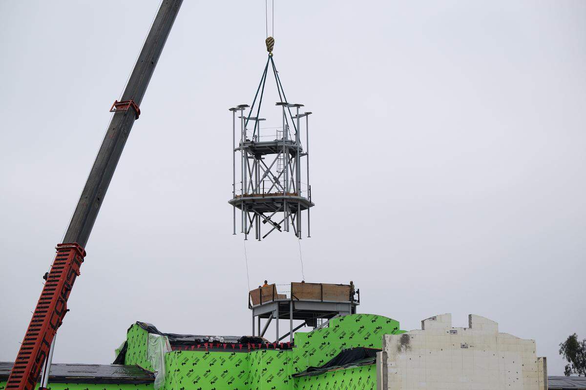 A crew lifts a section of metal framing as they build the tower at the Church of Jesus Christ of Latter-day Saints new temple on Dale Road in Modesto, Thursday, Dec. 19, 2024.
